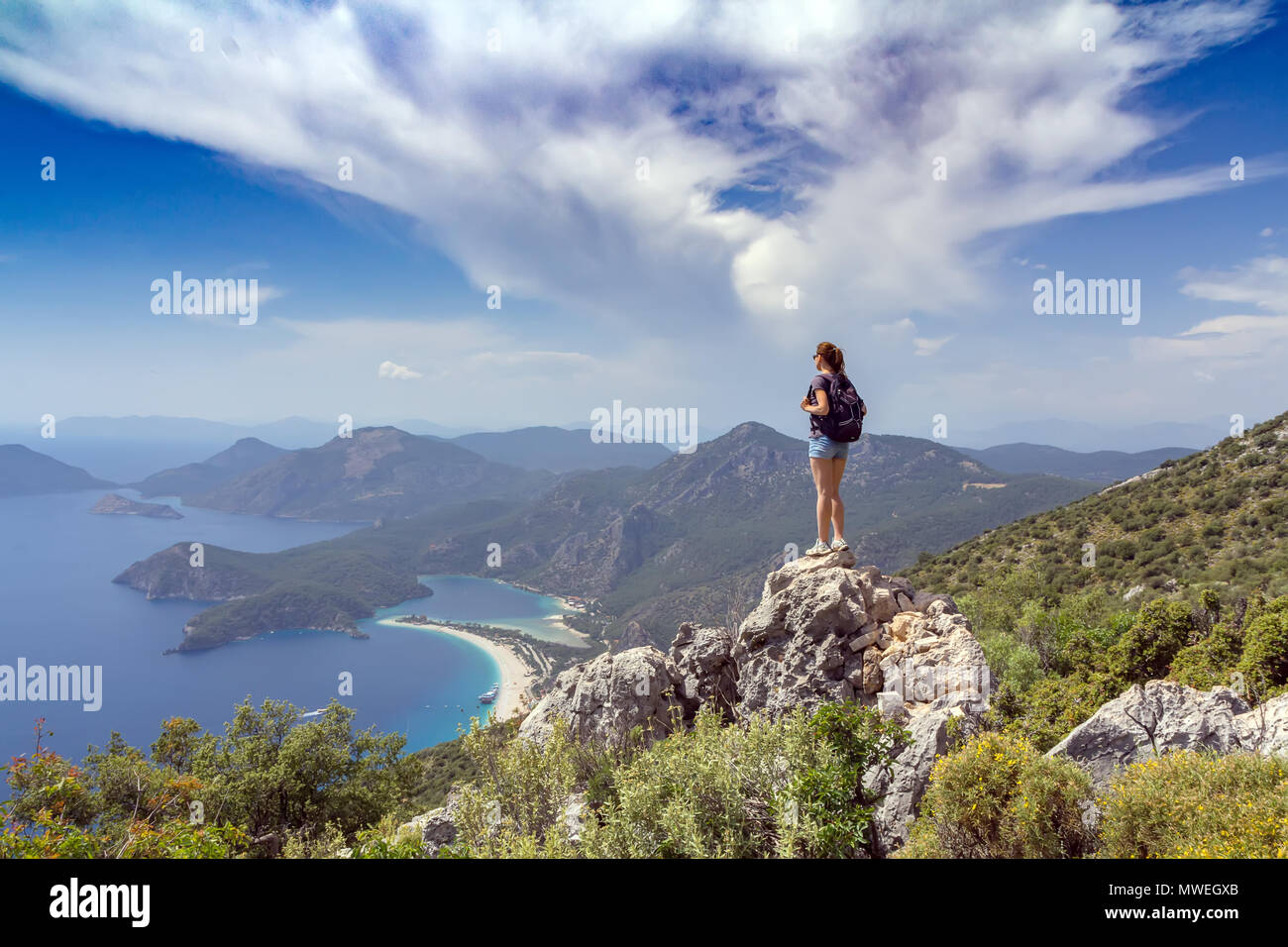 Hiker girl on the mountain top. Sport and active life concept. Oludeniz, Turkey Stock Photo