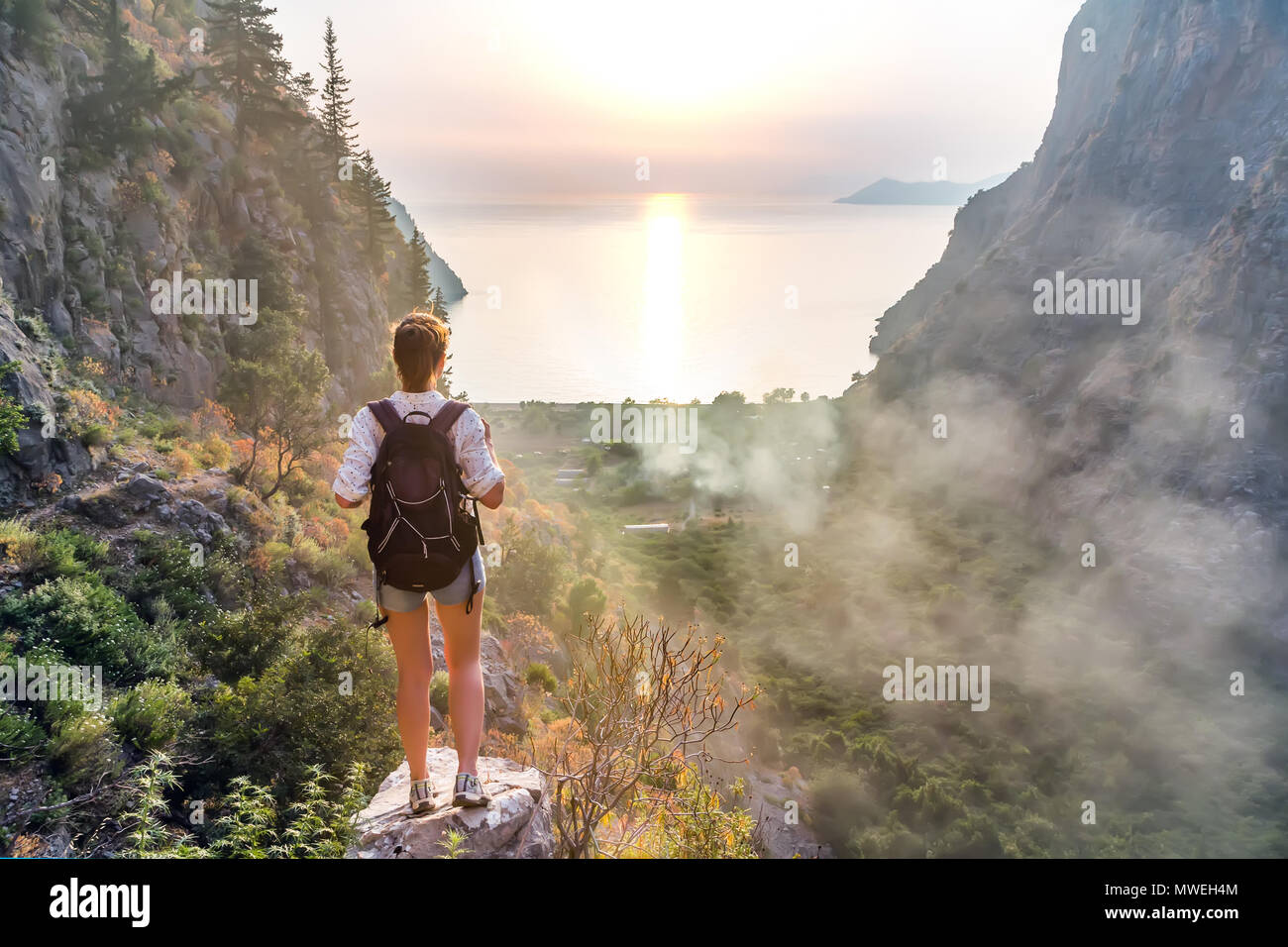 Hiker girl on the mountain top. Sport and active life concept. Valley of butterflies, Oludeniz, Turkey Stock Photo