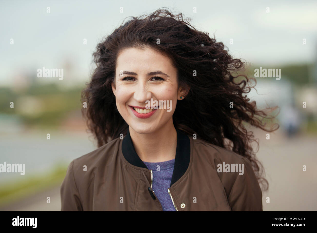 Portrait of attractive young brunette woman with long curly hair Stock ...