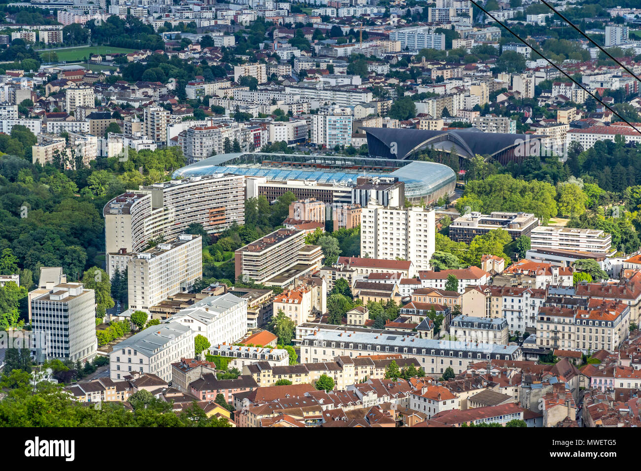 Aerial view of Grenoble old town. Stadium Stade des Alpes on the background. Auvergne-Rhone-Alpes region, France. View from above, from Grenoble Fort Stock Photo