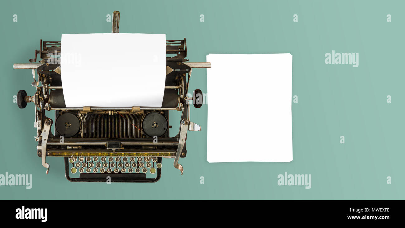 directly above shot of vintage manual typewriter and sheets of paper on desk Stock Photo