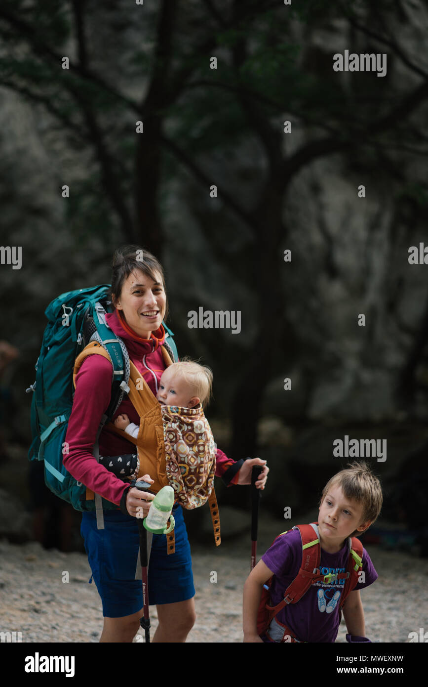 Young mother hiking with two kids Stock Photo
