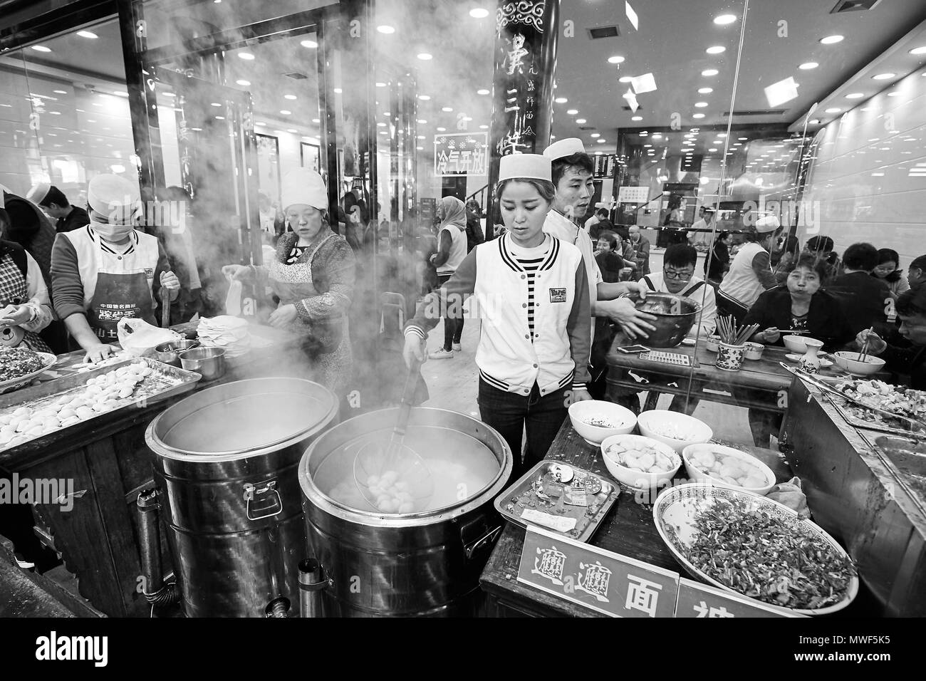 Xian, China - October 5, 2017: Street food preparation in the Muslim Quarter, well-known tourism site famous for its culture and food. Stock Photo