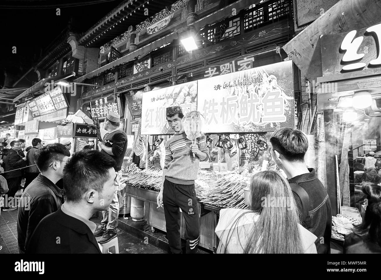 Xian, China - October 5, 2017: Street food vendor at the Muslim Quarter, well-known tourism site famous for its culture and food. Stock Photo
