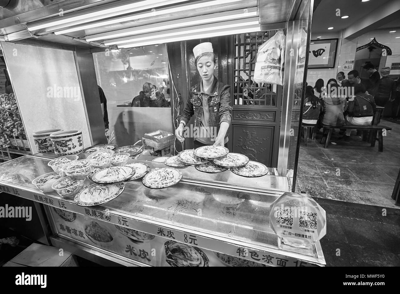 Xian, China - October 5, 2017: Street food vendor in the Muslim Quarter, well-known tourism site famous for its culture and food. Stock Photo