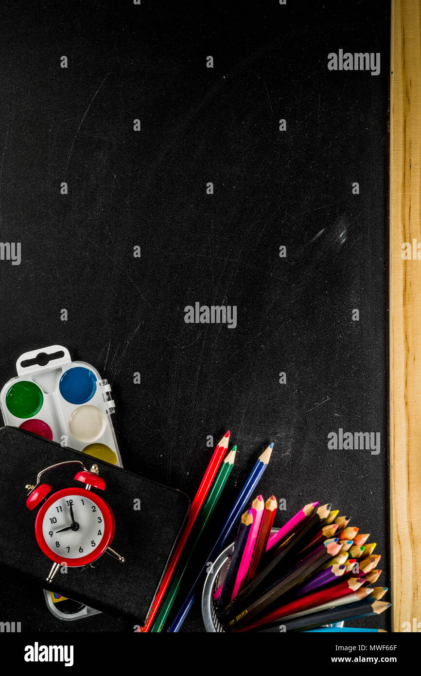 Back to school concept with books, alarm clock, color pencils ...
