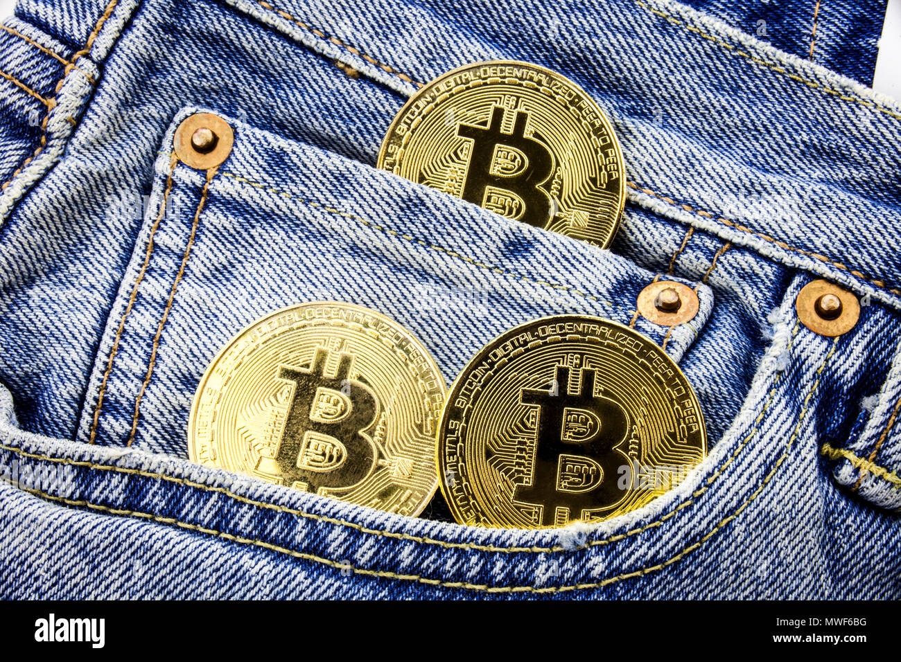 Three Golden Bitcoin Coins On The Pockets Of The Jeans Concept Of - 