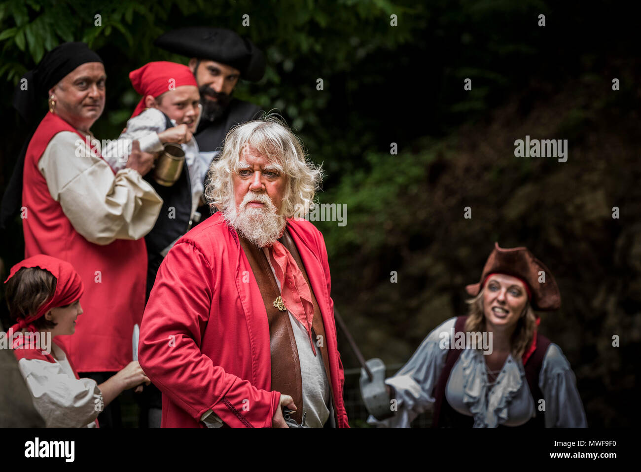 Acting - An amateur drama group in a performance at Trebah Garden Amphitheatre in Cornwall. Stock Photo