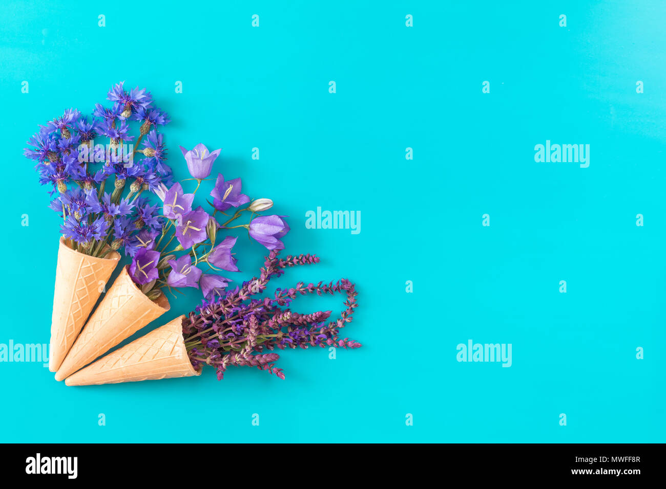 Three waffle cones with thyme, cornflower, blue bells and white flowers