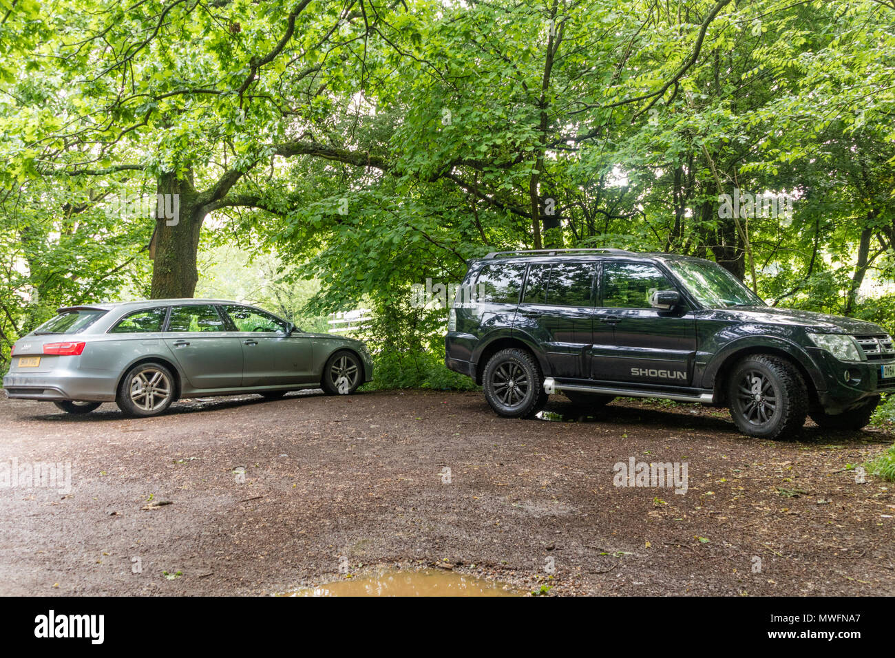 Inconsiderate parking, a 4x4 taking up two parking spaces in a rural carpark, England, UK Stock Photo