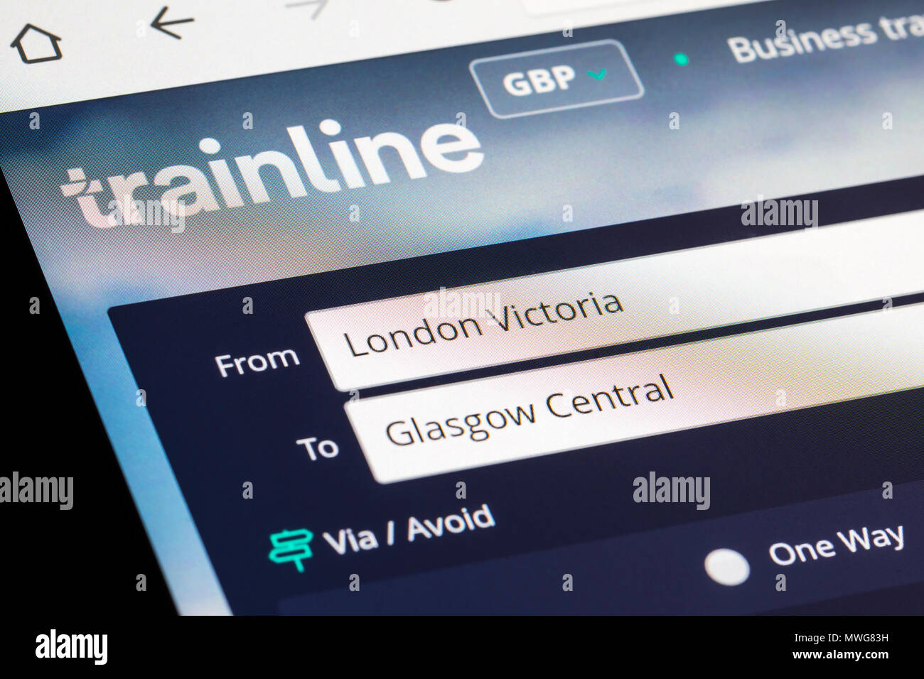 Trainline website for booking train journeys on the Internet in the UK. London Victoria to Glasgow Central. Taking the train. Booking trains online. Stock Photo