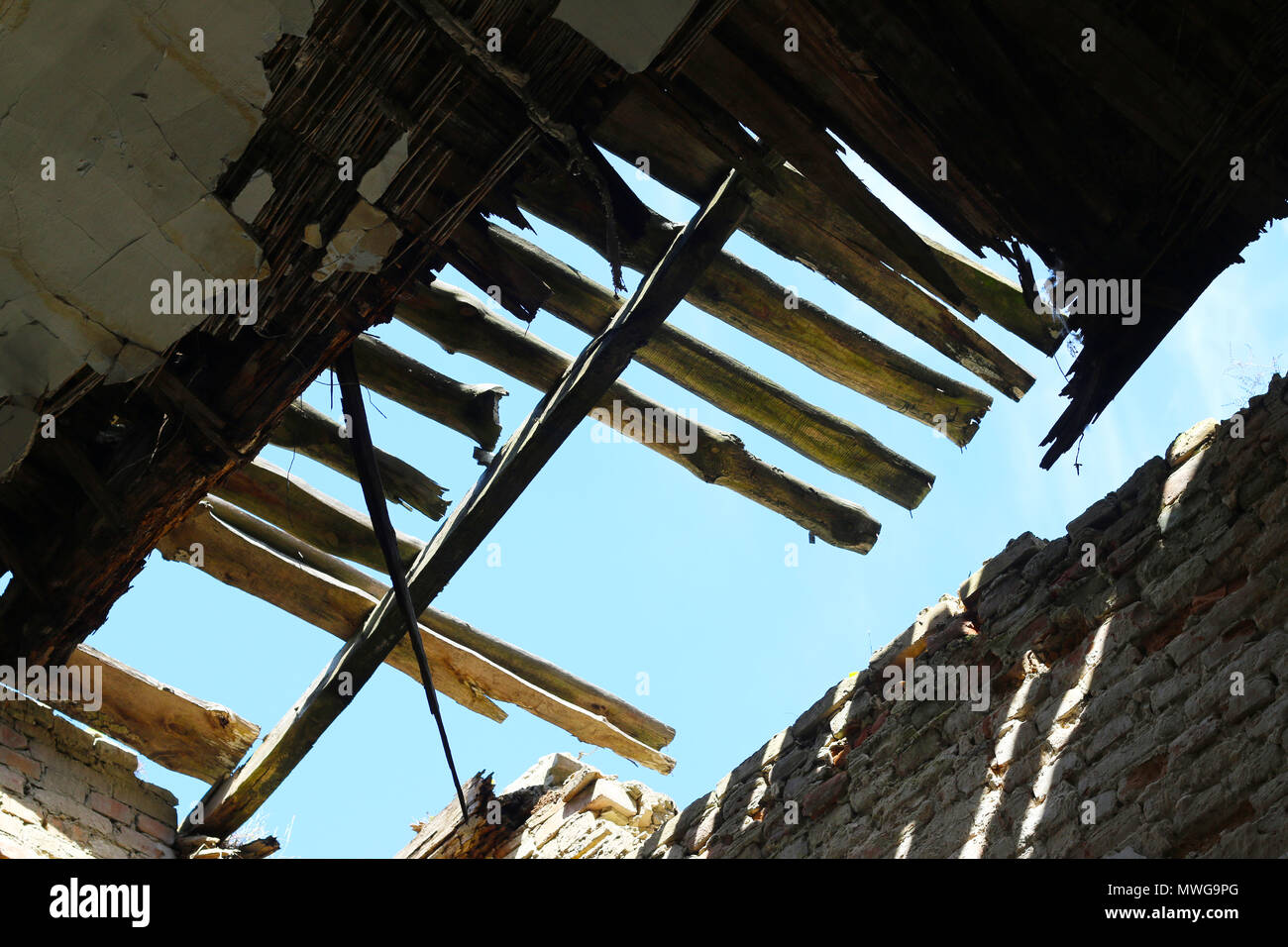 Ceiling in the old castle is destroyed. Big terrible hole in the dark abandoned building Stock Photo