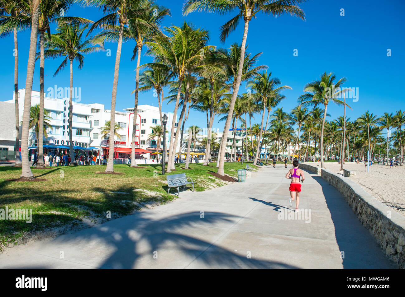 MIAMI - DECEMBER 27, 2017: Morning joggers on the beachfront boardwalk promenade at Lummus Park in South Beach. Stock Photo