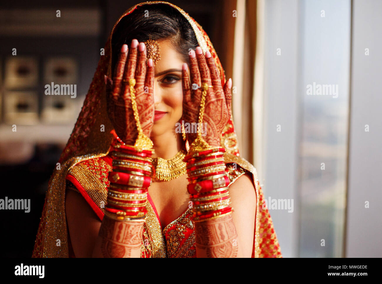 Pakistani & Indian bride wedding style showing Earring, Bangles & beautiful Mehndi design Stock Photo