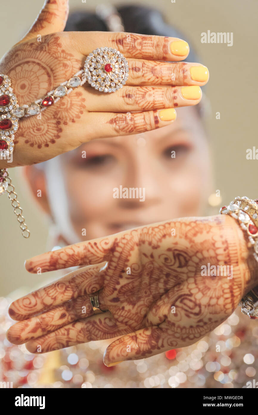 Pakistani & Indian bride wedding style showing Earring, Bangles & beautiful Mehndi design Stock Photo