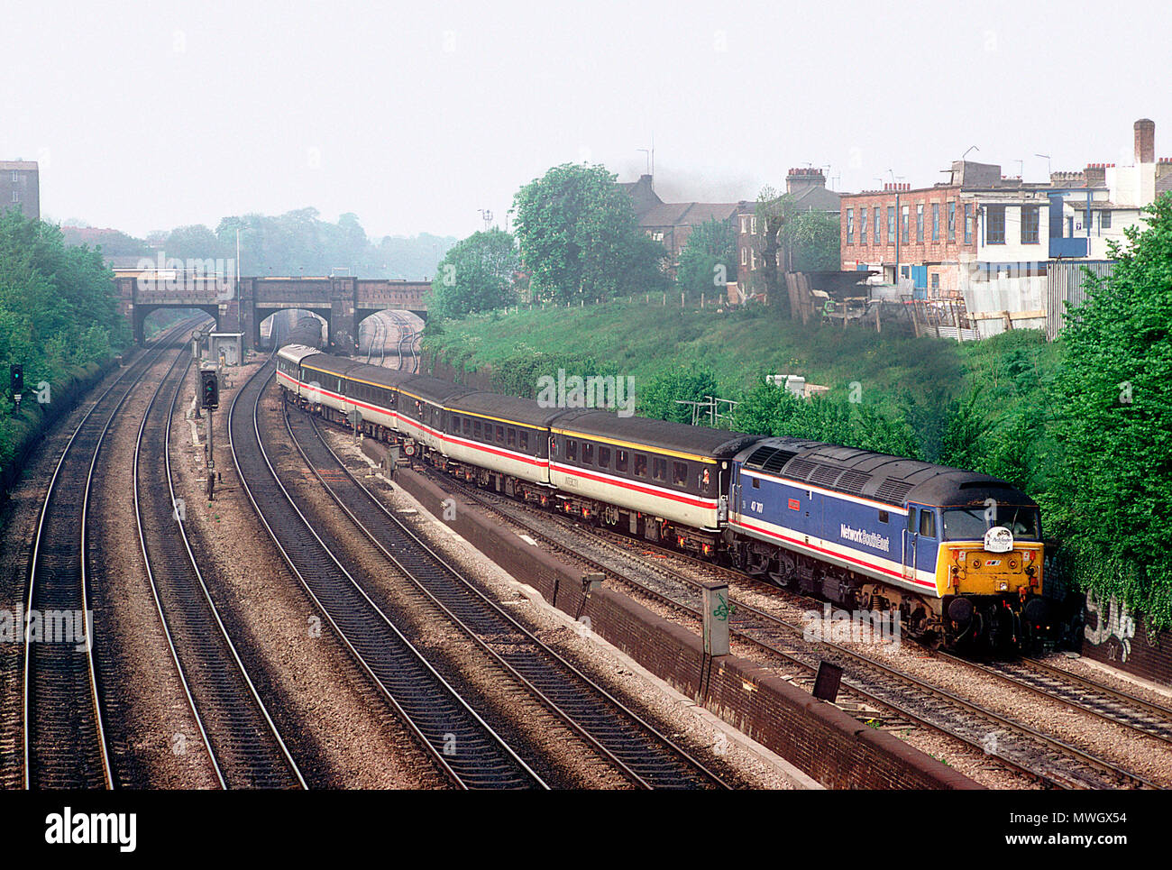 A class 47 diesel locomotive number 47707 working a charter train begins the climb of Acton Bank in west London on the 1st May 1993. Stock Photo