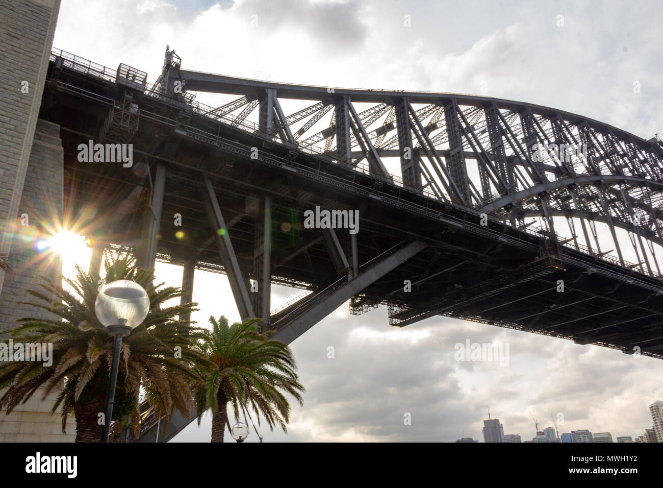 The sun peeking through the Sydney Harbour Bridge Stock Photo