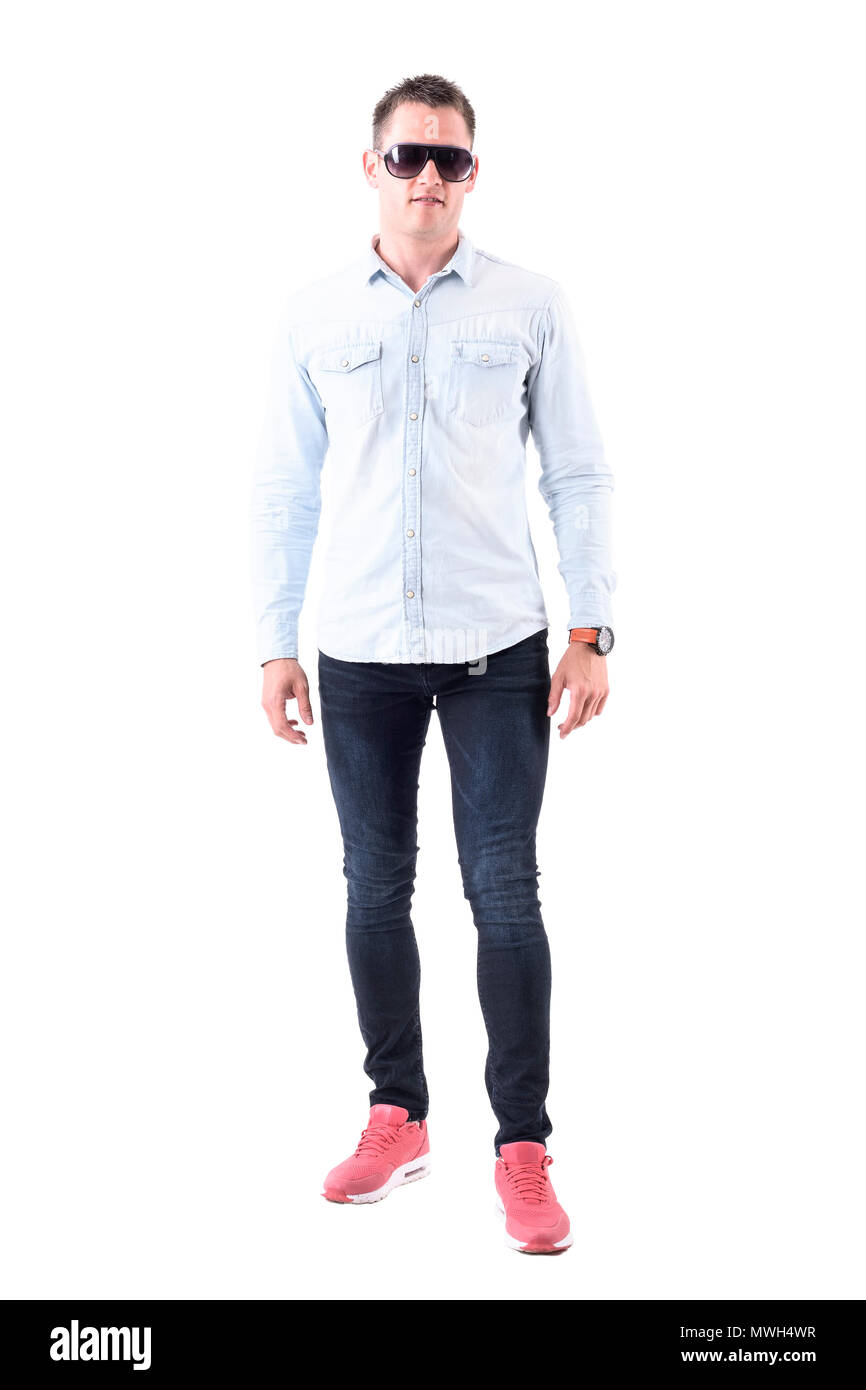 Man wearing light blue shirt, jeans and pink sneakers with sunglasses  looking at camera. Full body isolated on white background Stock Photo -  Alamy