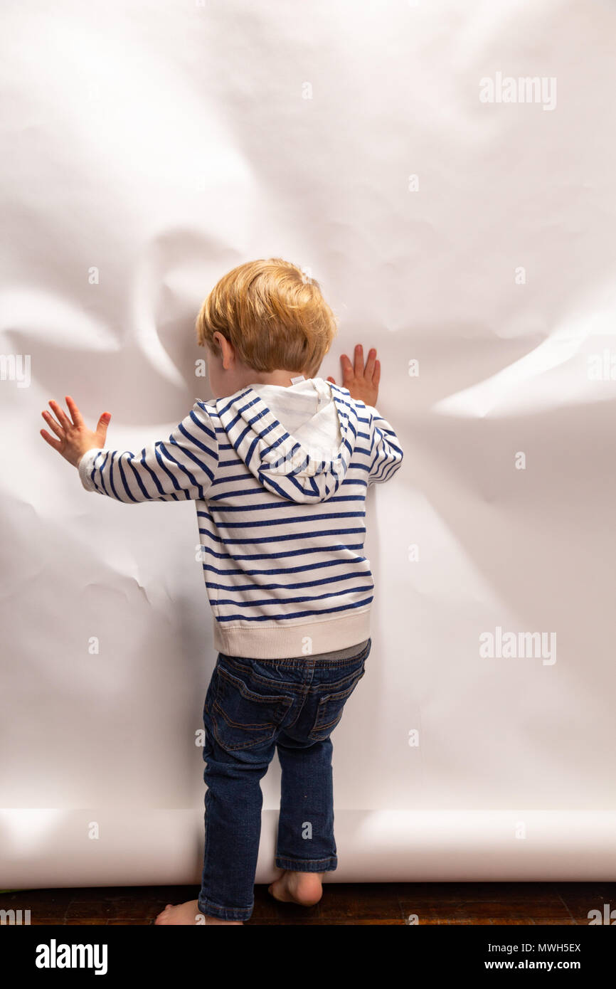 Young Caucasian Toddler Boy Acts Silly On A Photo Shoot In Front of A White Background Stock Photo