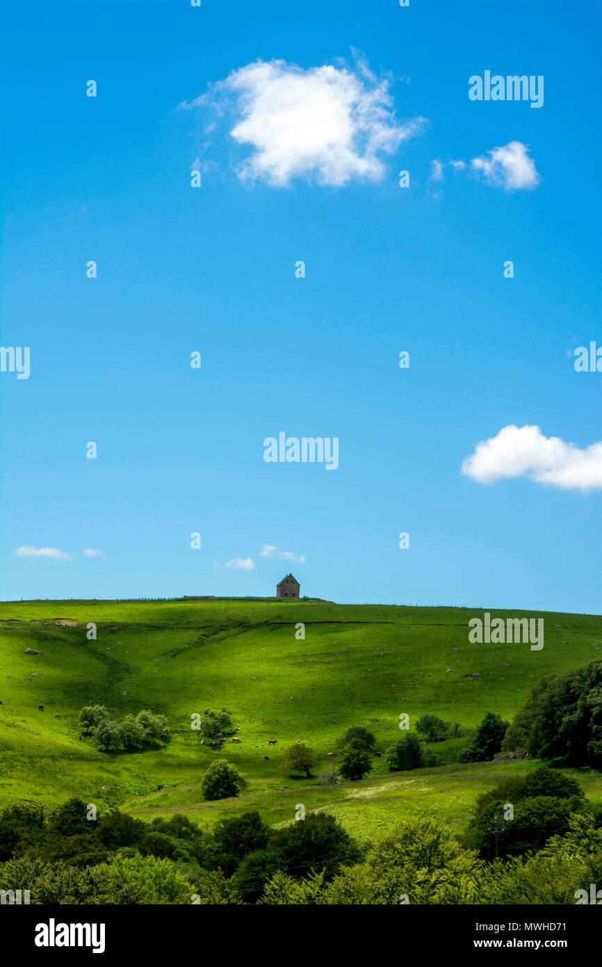 Isolated farm. Regional Nature Park of the Volcanoes of Auvergne. Puy de Dome. Auvergne. France Stock Photo