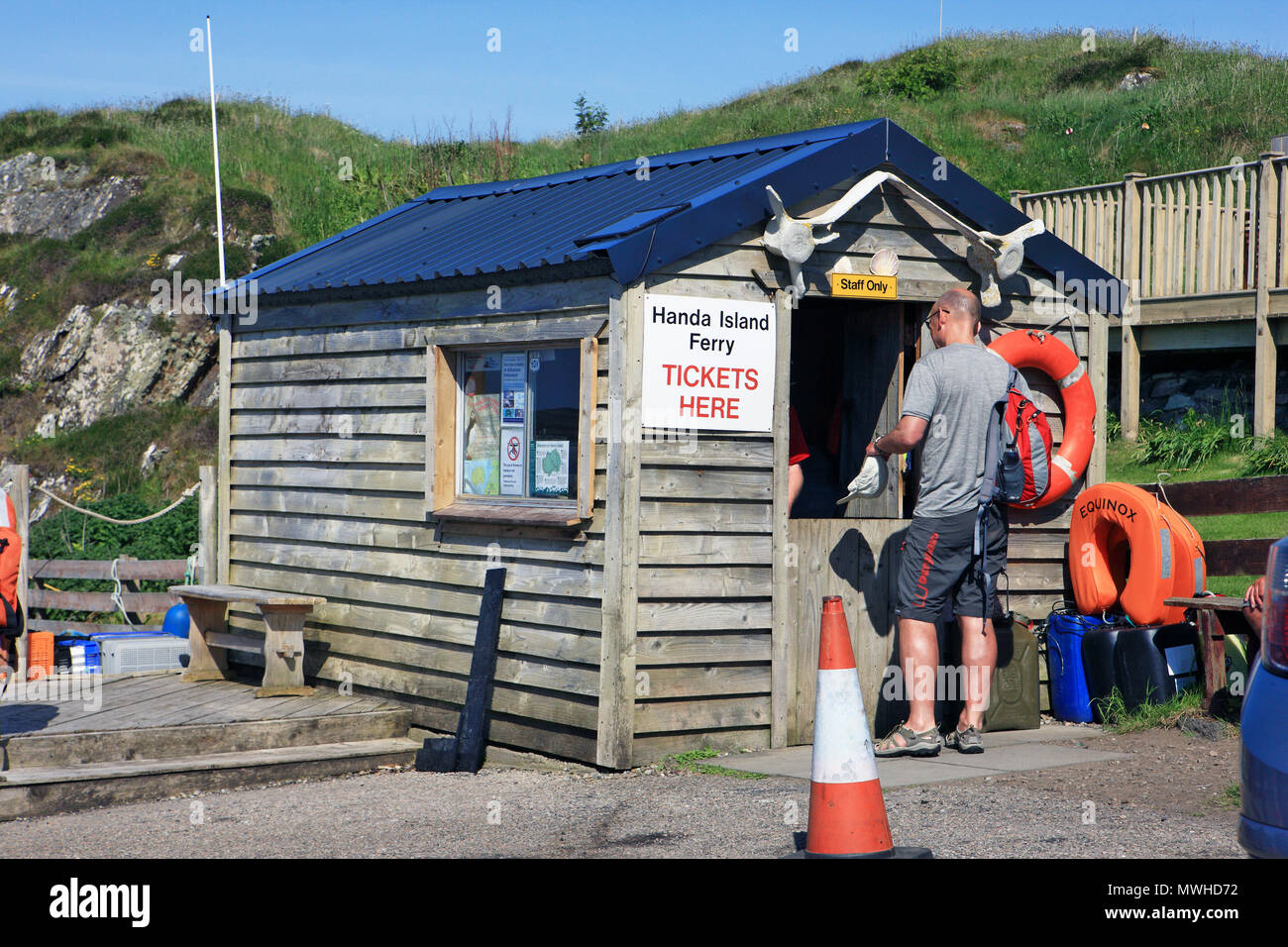 Man buying ferry tickets for Handa Island in Tarbet trips to Handa near Scourie, Lairg, Sutherland, Scotland Stock Photo