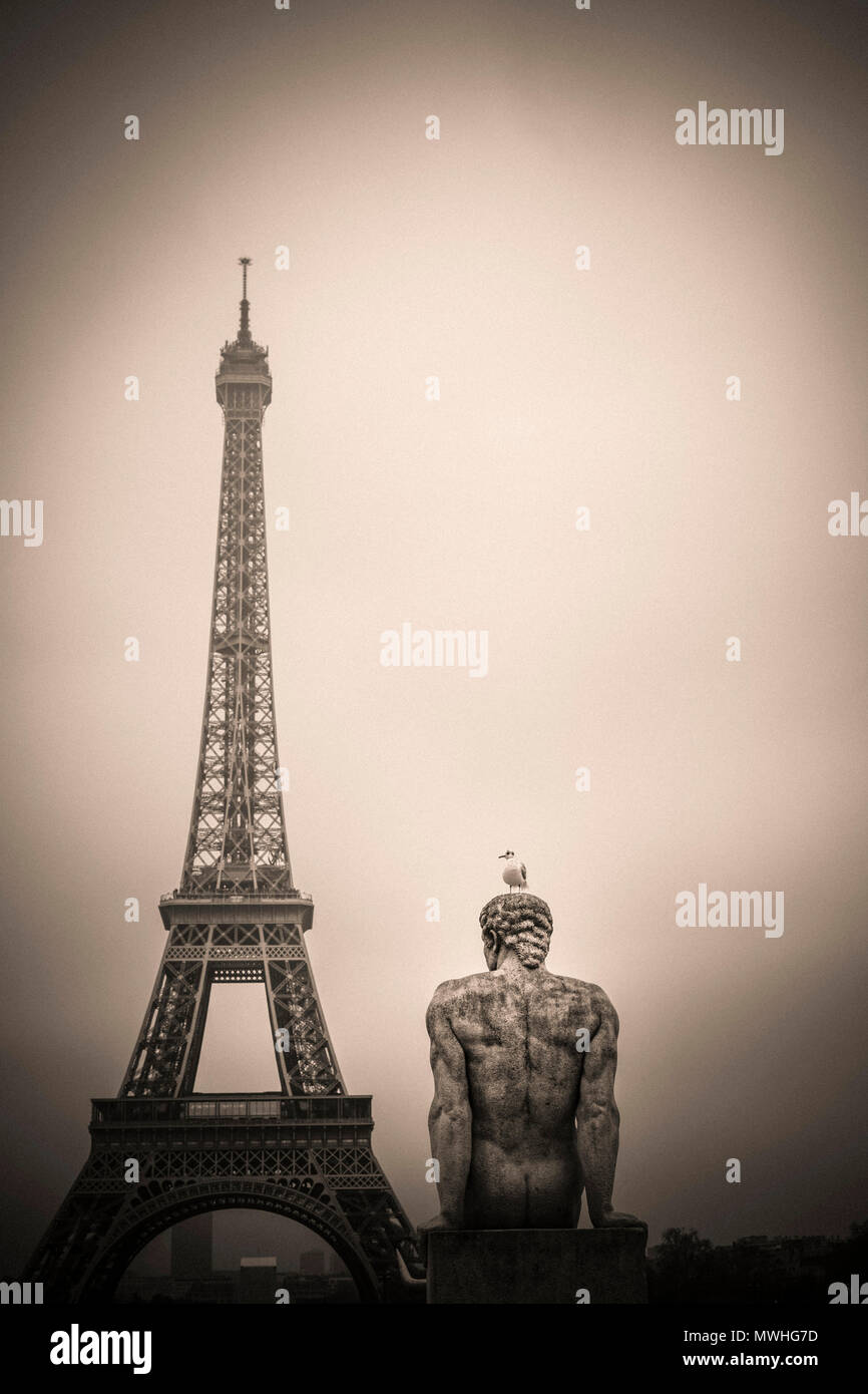 Eiffel tower and l'Homme (the Man) statue by artist Pierre Traverse, Paris, Ile De France, France, Europe Stock Photo