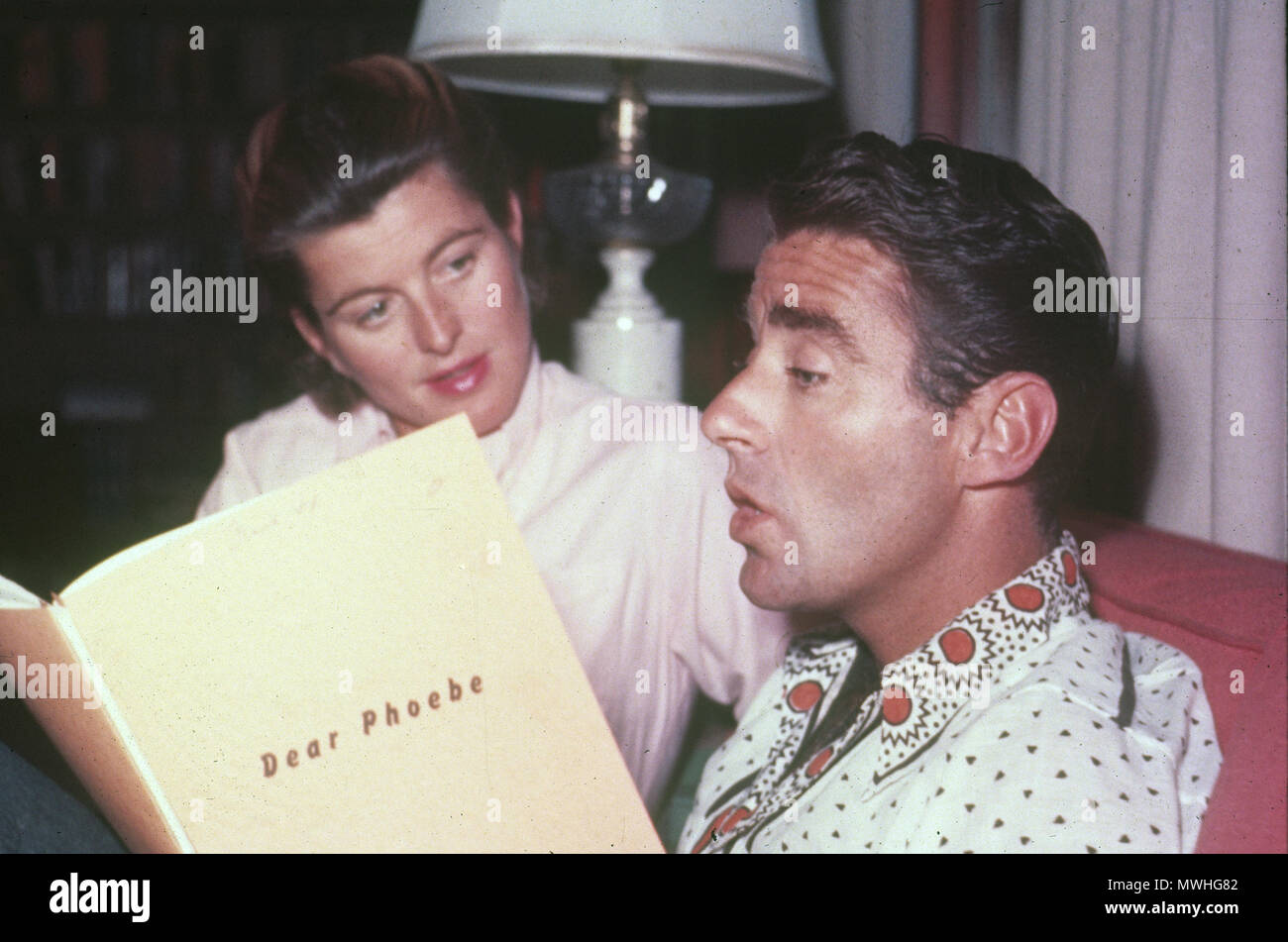 PETER LAWFORD (1923-1984) Anglo-American film actor with his first wife Patricia in 1954. He is reading the script of his film Dear Phoebe produced that year. Stock Photo