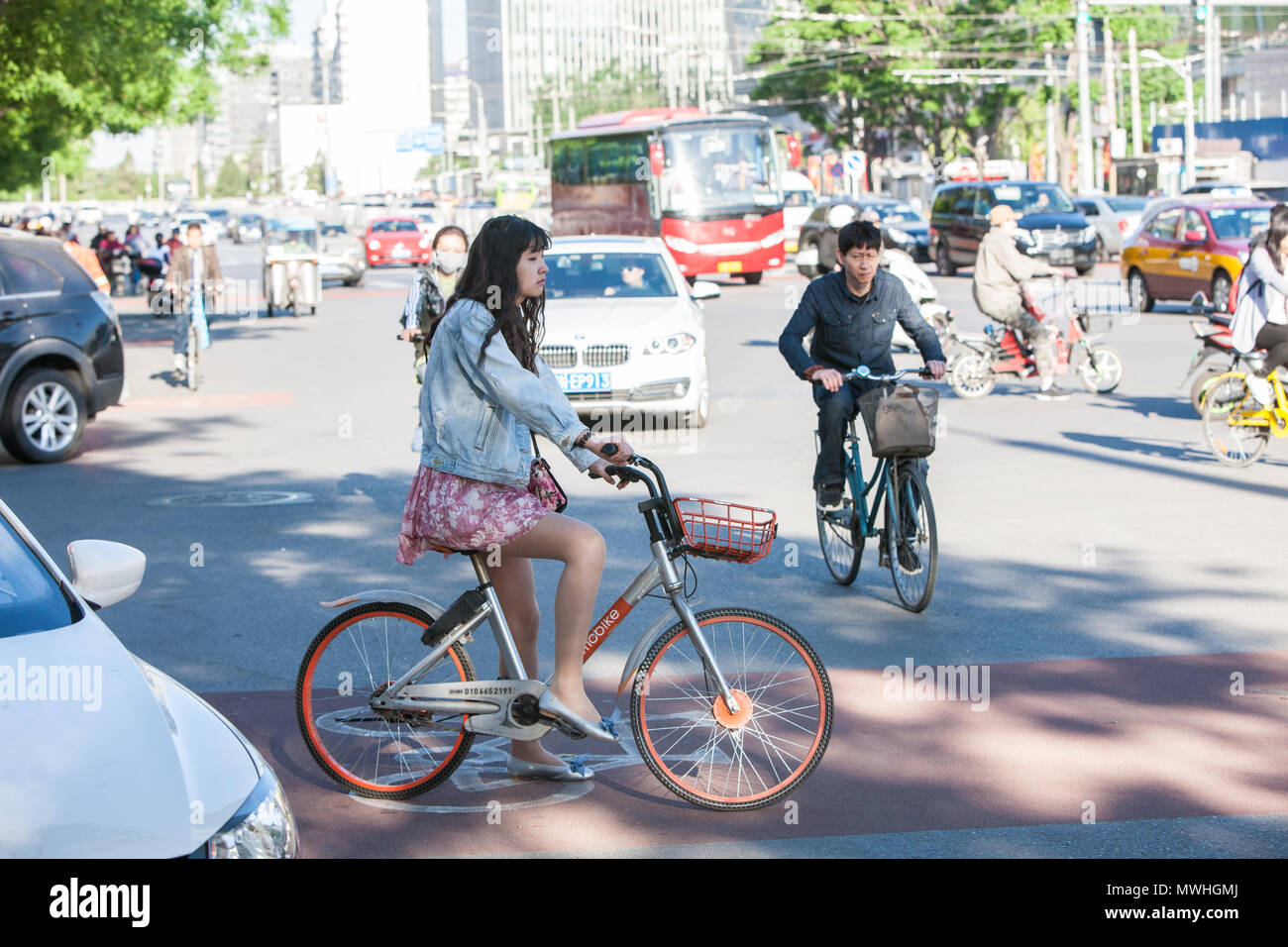 Woman,cycling,summer,floral,short,skirt,in,centre,of,Beijing,Peking,capital,city,Peoples  Republic of China,China,Chinese,Asia,Asian Stock Photo - Alamy