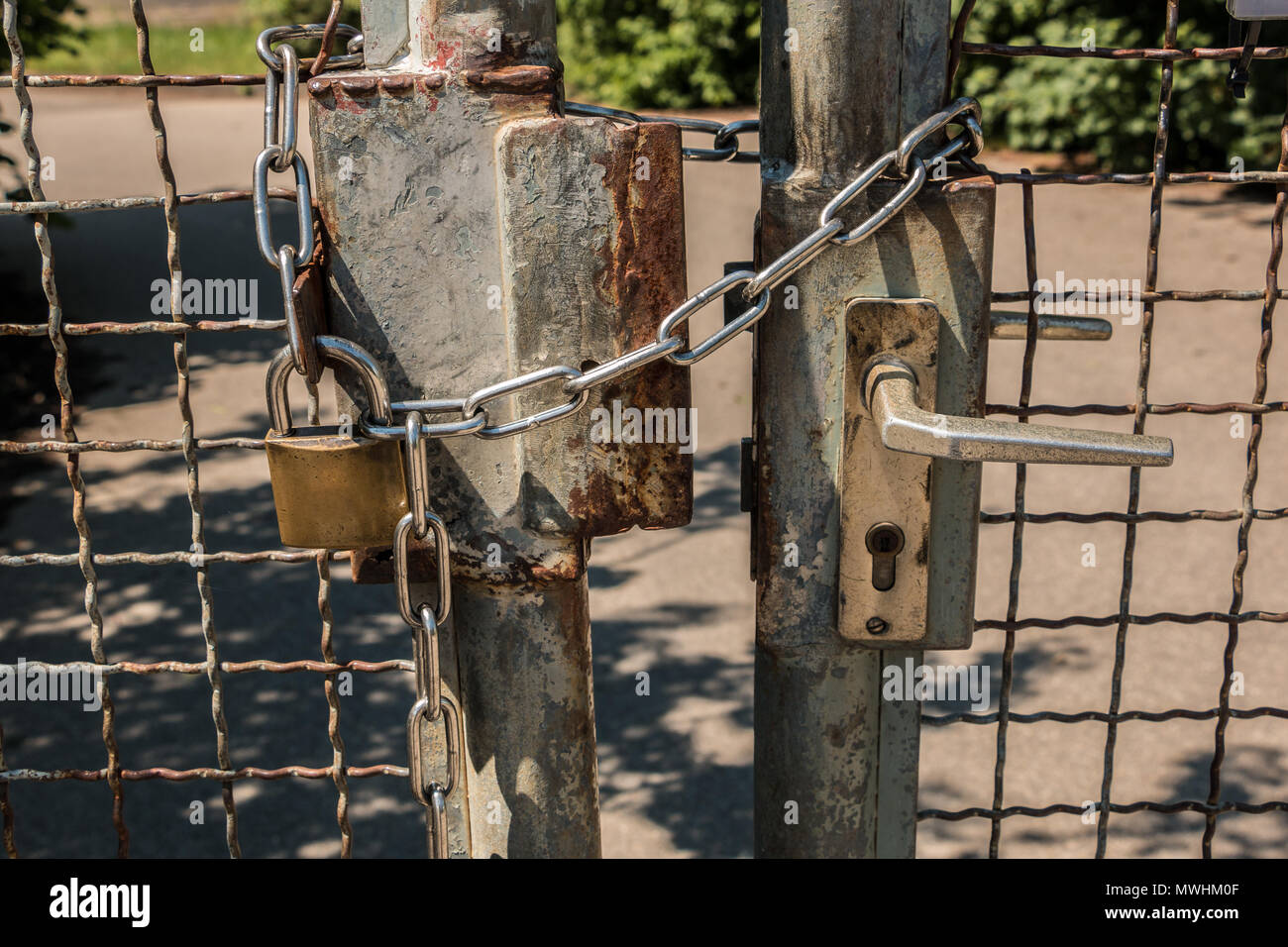 Closed gate with big steel chain and padlock Stock Photo