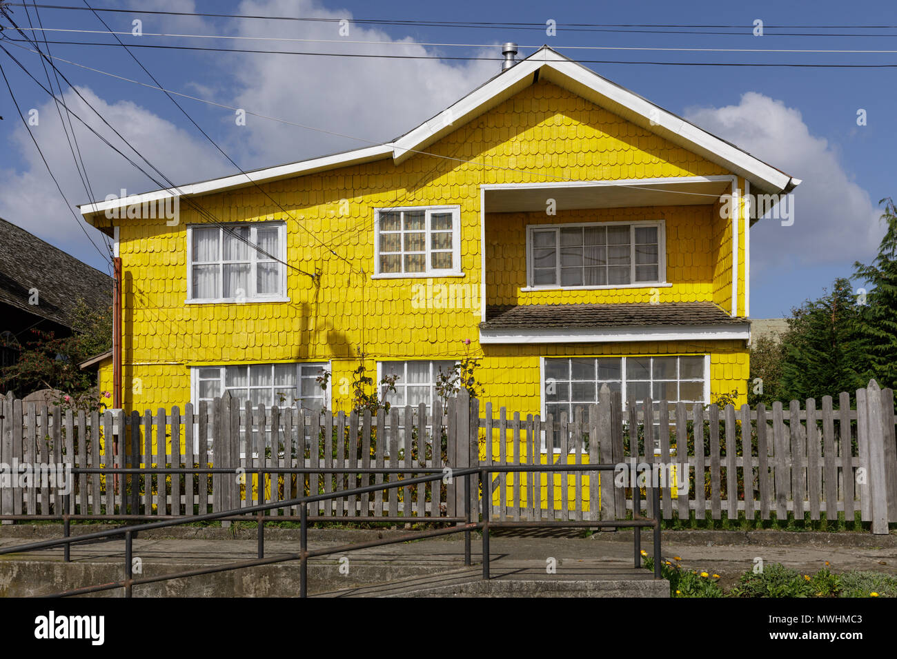 Quinchao Island, Chiloé, Chile: Yellow painted tejuelas shingles, alerce wood, in the vllage of Achao. Stock Photo