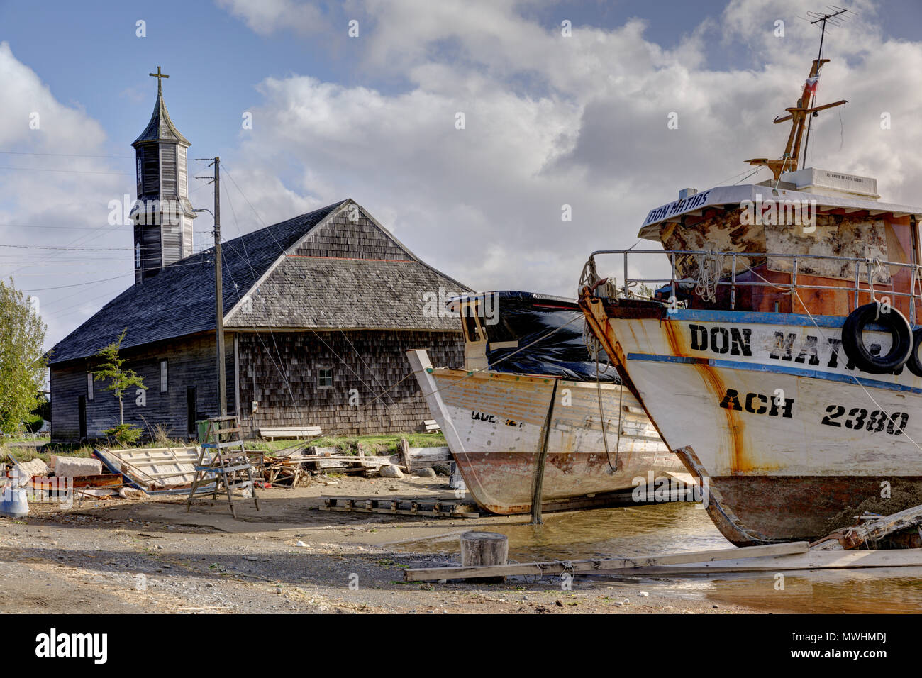 Chiloé Island, Chile: The Unesco World Heritage Church in San Juan sits next to the shipyard. Stock Photo