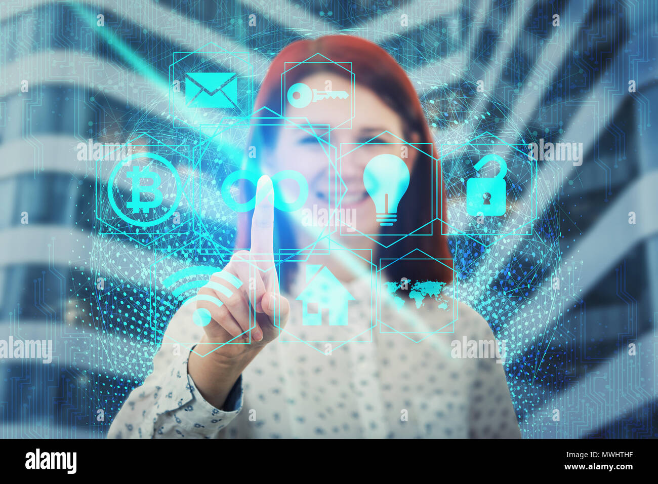 Smiling woman touch digital screen interface. Press the blue infinity icon for limitless access to all features. Modern technology concept, the endles Stock Photo