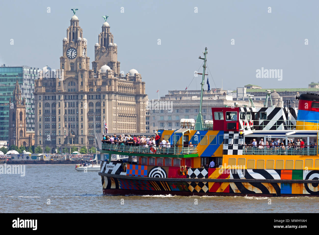 A crowded Razzle Dazzle Snowdrop ferry passes in front of the Liver Building on the River Mersey