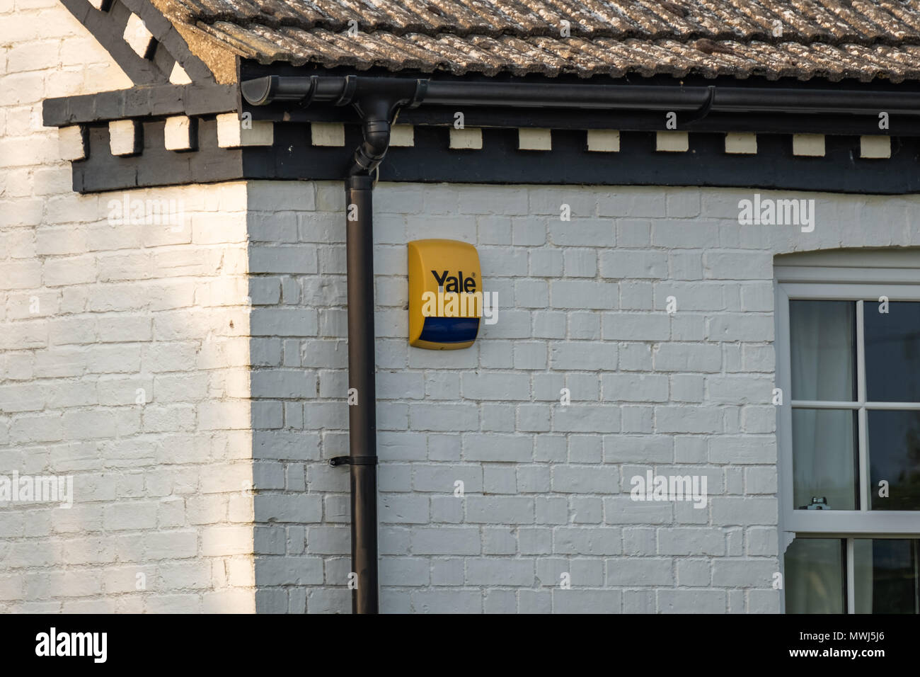 Isolated view of a residential Alarm and warning strobe seen fitted to the outside of a bricked house in the UK capital. Stock Photo