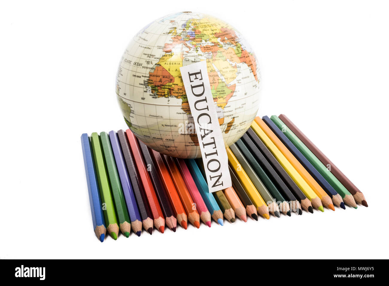 Colour pencils with globe and education note on them on a white background Stock Photo