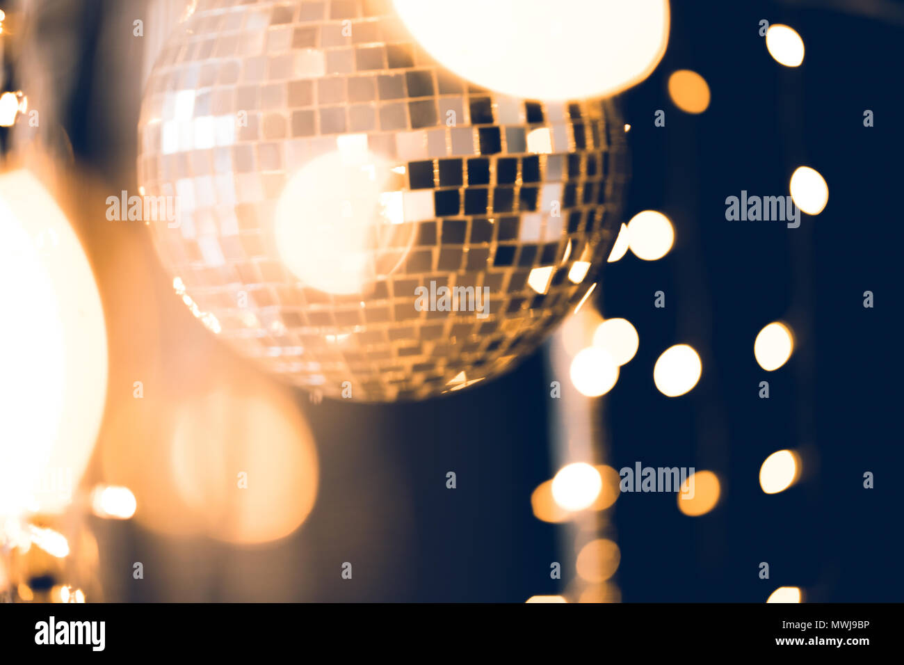 beautiful disco ball with golden garland on black Stock Photo Alamy