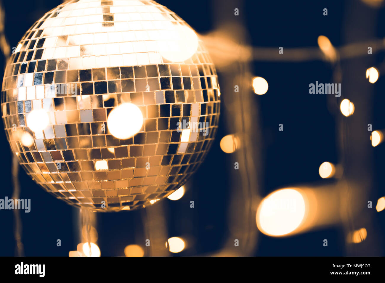 glossy disco ball with beautiful garland on foreground Stock Photo Alamy