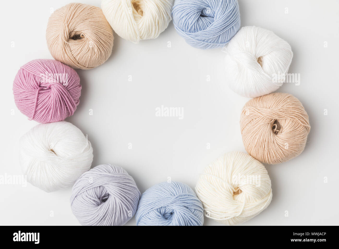 top view of circle of colored yarn balls on white background Stock ...