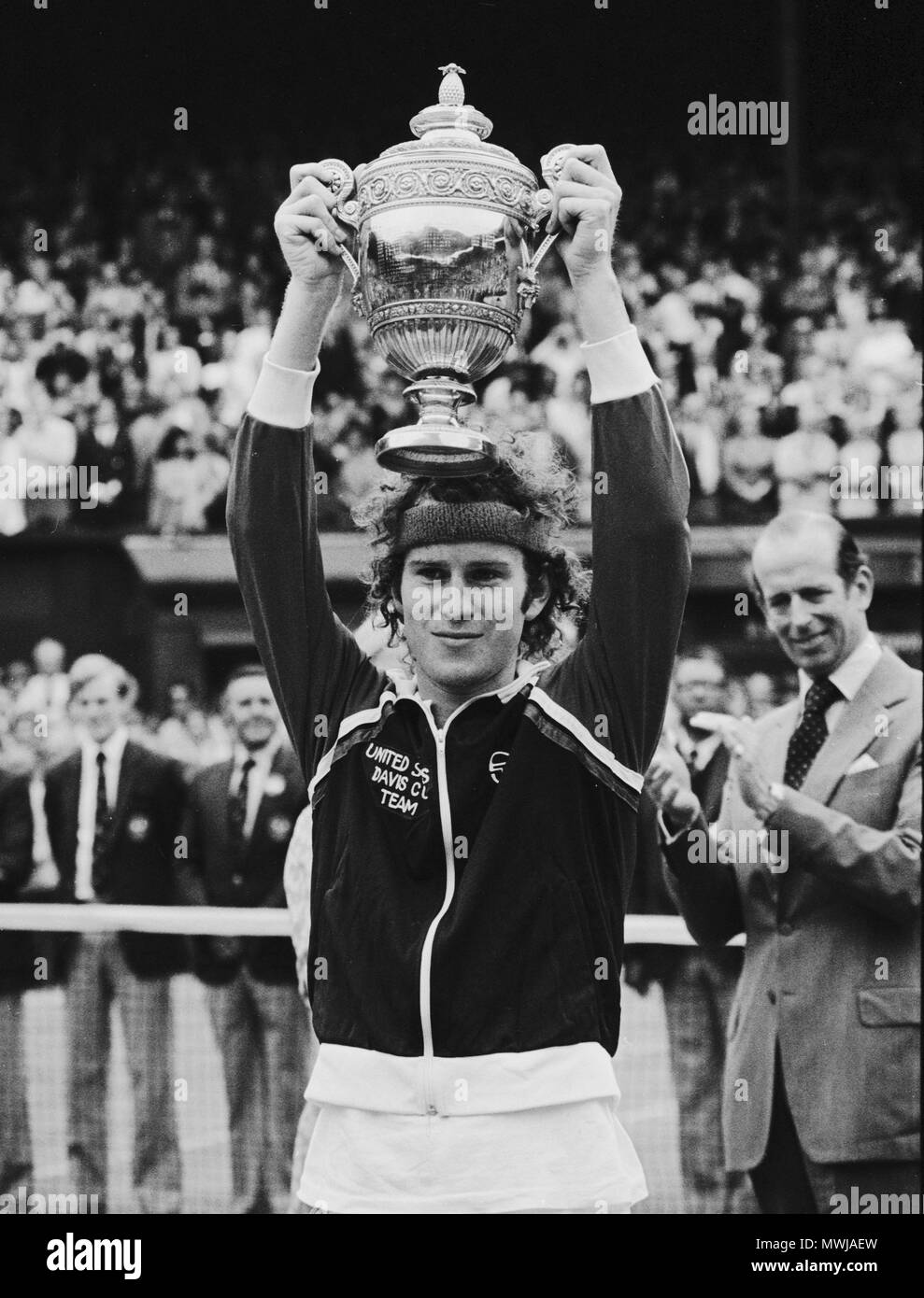 John mcenroe holds aloft the trophy following his victory Black and ...