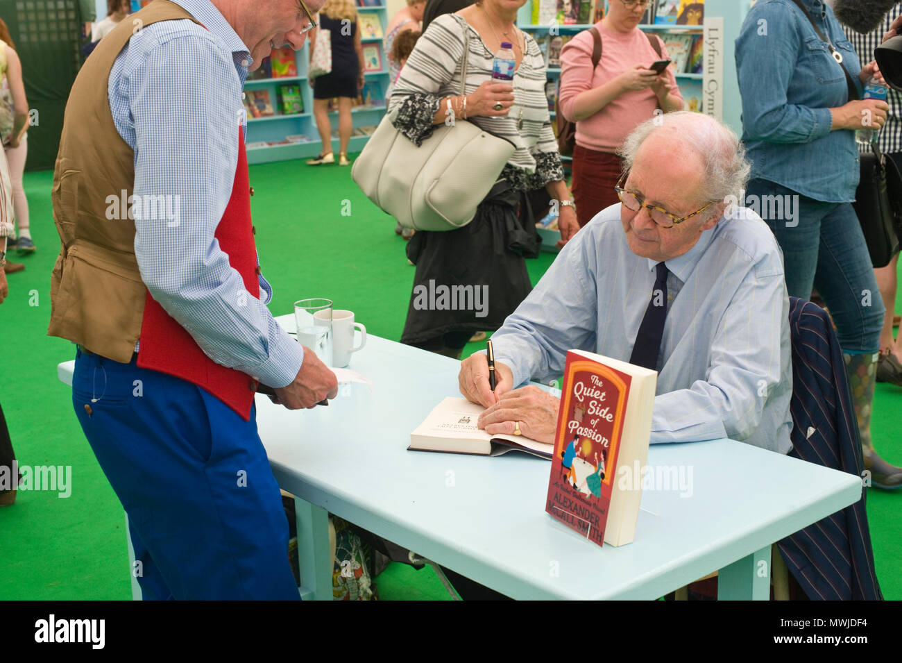 Alexander McCall Smith signing books for fans in the bookshop at Hay Festival 2018 Hay-on-Wye Powys Wales UK Stock Photo