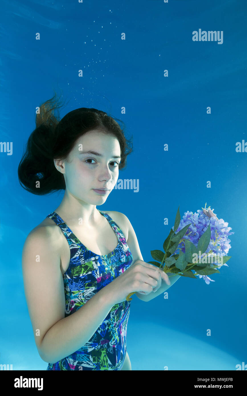 Underwater portrait girl with a flower Stock Photo