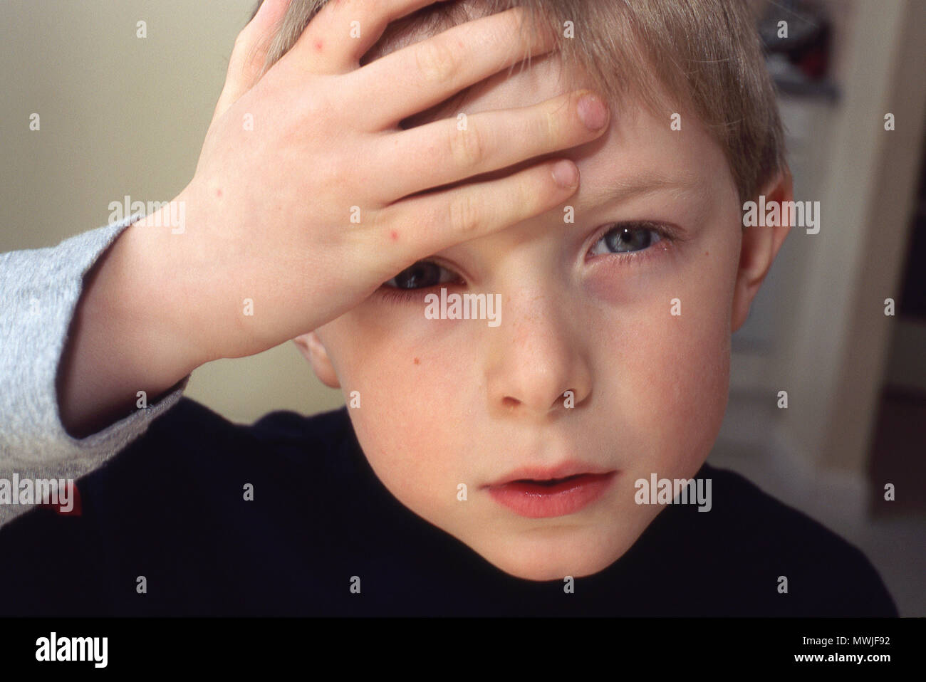 Six year old boy with a headache Stock Photo