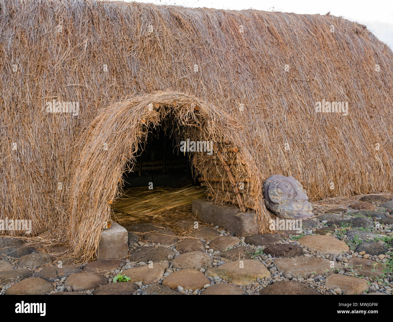 Entrance of reconstructed traditional thatched boat shaped house called