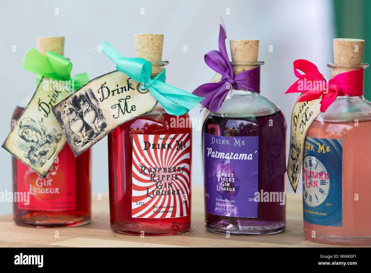 Speciality drink me flavoured gin bottles at a food festival. Oxfordshire, England Stock Photo