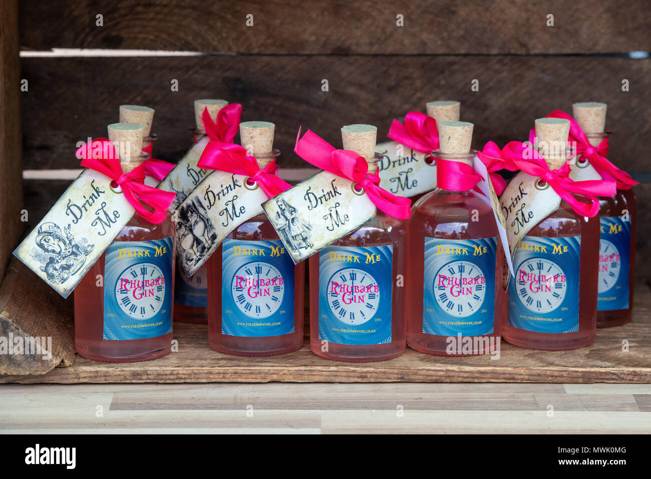 Speciality drink me rhubarb gin bottles at a food festival. Oxfordshire, England Stock Photo