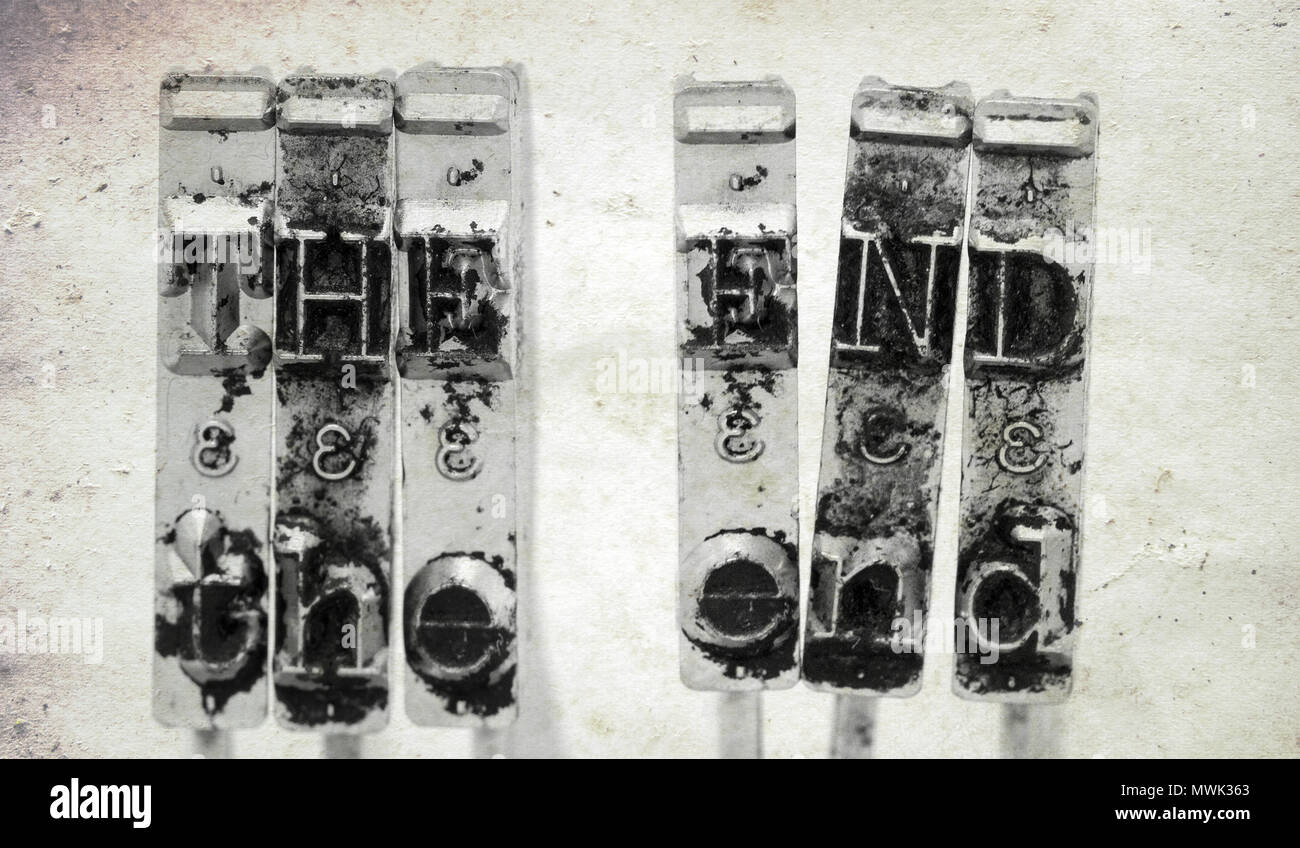 The words THE END with old typewriter hammers with old paper background