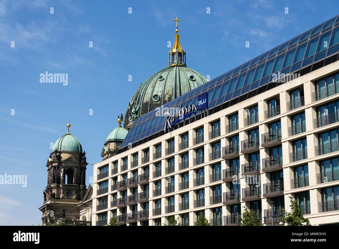 BERLIN, GERMANY - MAY 15 2018: Radisson Blu hotels and resorts logo on the building of hotel with Berlin Cathedral, Berliner Dom in background on May  Stock Photo