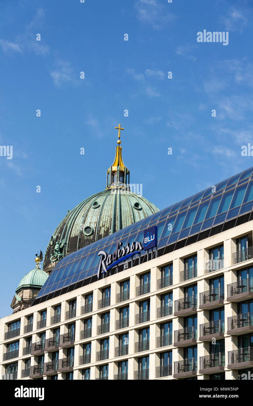 BERLIN, GERMANY - MAY 15 2018: Radisson Blu hotels and resorts logo on the building of hotel with Berlin Cathedral, Berliner Dom in background on May  Stock Photo