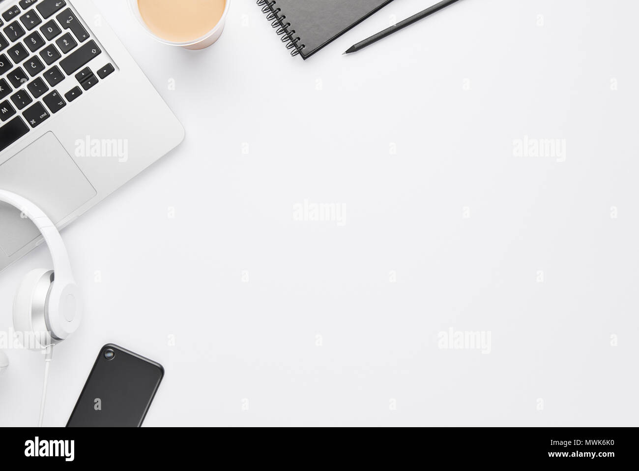 Work space concept top view of laptop white headphones