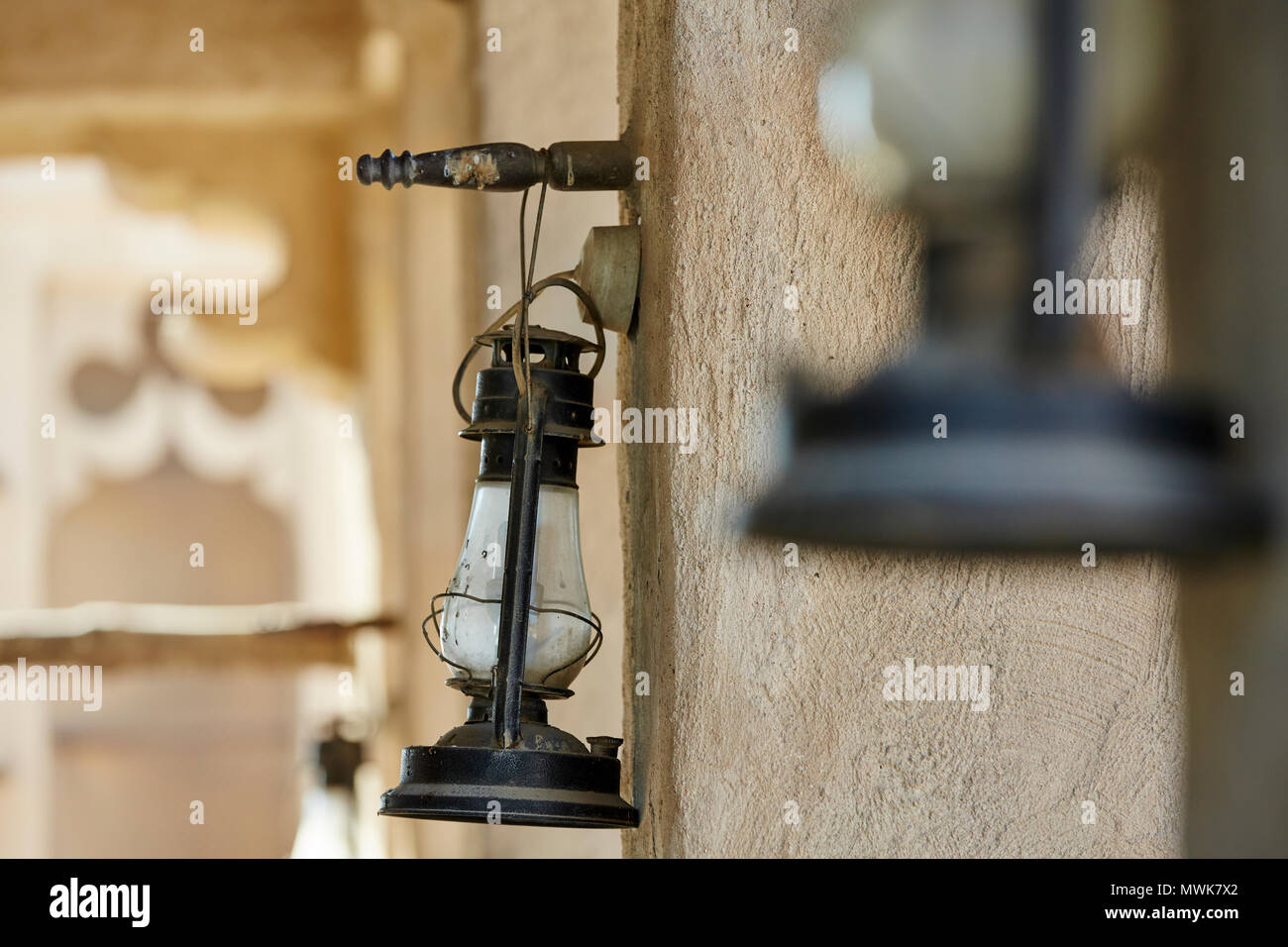 Old antique oil lantern hanging on wall Stock Photo - Alamy